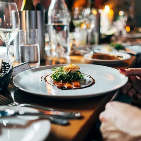 A plated dish on a candlelit restaurant table